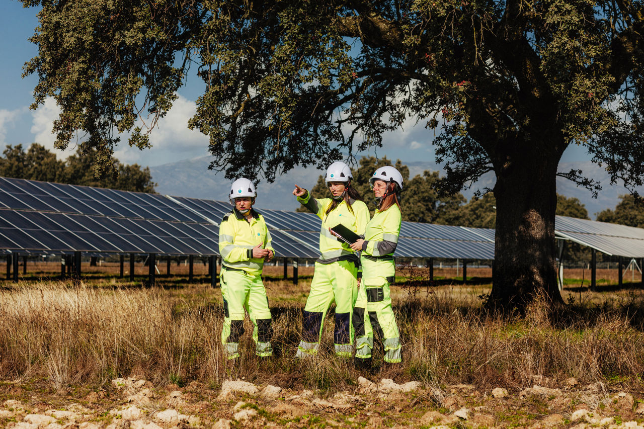 Persone vicino a impianto fotovoltaico con dispositivi di sicurezza